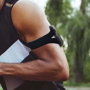 Arm band on a muscular mans arm - worker heat monitoring system by Kenzen