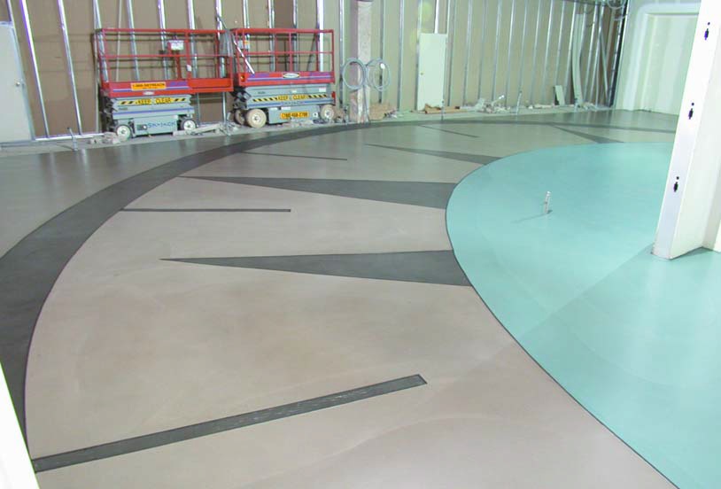 A radial line of concrete creating a clock-like affect brings life to an otherwise drab room.