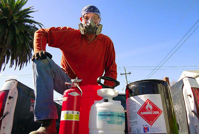 I now dress appropriately when spraying flammable solvents: long-sleeved shirt and pants, and headscarf, in natural fibers; respirator and goggles; leather boots and gloves. Theres a bucket and rag in case the hose bursts and an appropriate fire extinguisher and water hose with a trigger nozzle.