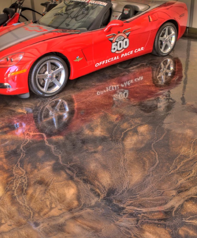 In January 2009, decorative concrete artisan Rod Burton of A Gorgeous Floor installed a high-sheen, acid-stained concrete floor in shades of brown and black in the garage, creating a stunning yet not overpowering backdrop for the prized automobile.