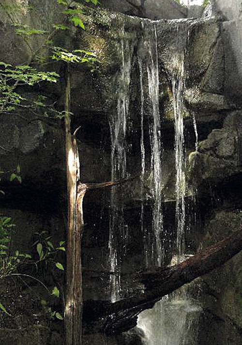 Water fall sculpted of concrete seems life like.