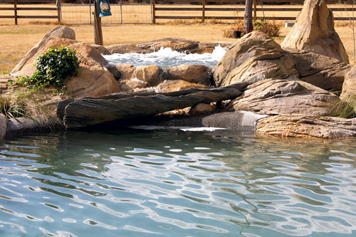 Bubbling hot tub sculpted of concrete fits into a desert scene perfectly.