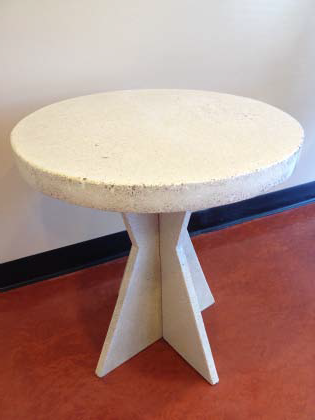 Small white concrete table in a concrete contractors showroom