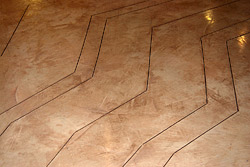 After diamond-grinding the old concrete surface to start the project, Westdeck primed the floor using Mapei Primer L, a solvent-free acrylic primer that is intended to improve the bond between a concrete substrate and an underlayment or topping.