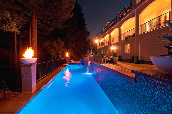 In an effort to help reduce slipping around the pool, workers sealed the deck with low-gloss lacquer-based sealer and broadcast fine glass with amber and green colors.