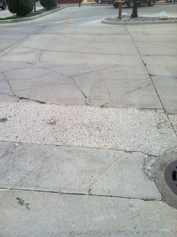 First Federal Savings Bank, Sheridan, Wyo., asked Doug Carlton if there was an overlay that could improve their cracked, uneven parking lot. He told them no. The crack pattern shows a problem beyond random cracking. He guessed that the concrete is too thin or not properly reinforced, or that the subgrade had failed. Photo courtesy of Doug Carlton