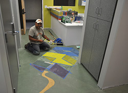 Stenciled and painted kite on concrete floor