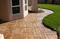 a stamped concrete patio with sealer on it