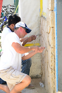 Hand carving a vertical wall in concrete