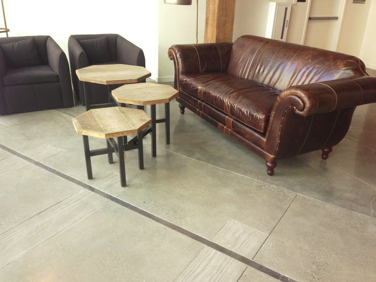 Here, Bay Area Concretes used a specially designed stamping mold to give the impression of railroad ties and embedded steel rails in the colored and polished topping slab.