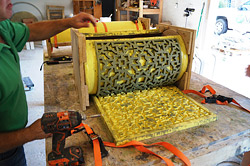 To make this warped concrete end table, Bill Sheets applied Polytek Mold release to a rubber lattice form, then filled it in with self-consolidating GFRC mix. He and Eric Schaeffer then warped the panel on a cylindrical form.