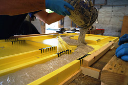 Sheets fills in the rubber mold for an end table with self-consolidating GFRC mix.