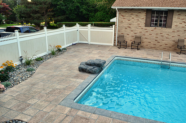 The new dive rock is more kid-friendly than the old diving board. The homeowner picked out a waterfall and LED lighting to install below it.