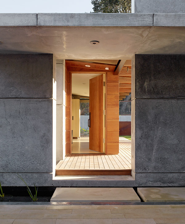 Cross a moat and youll enter the concrete portal to House 7s guest house. The flanking wall and canopy are extensions of the main house wall and upper deck. The 450-square-foot guest house in Los Altos Hills, California, has its own deck, bathroom and living space. Photo by Matthew Millman Photography