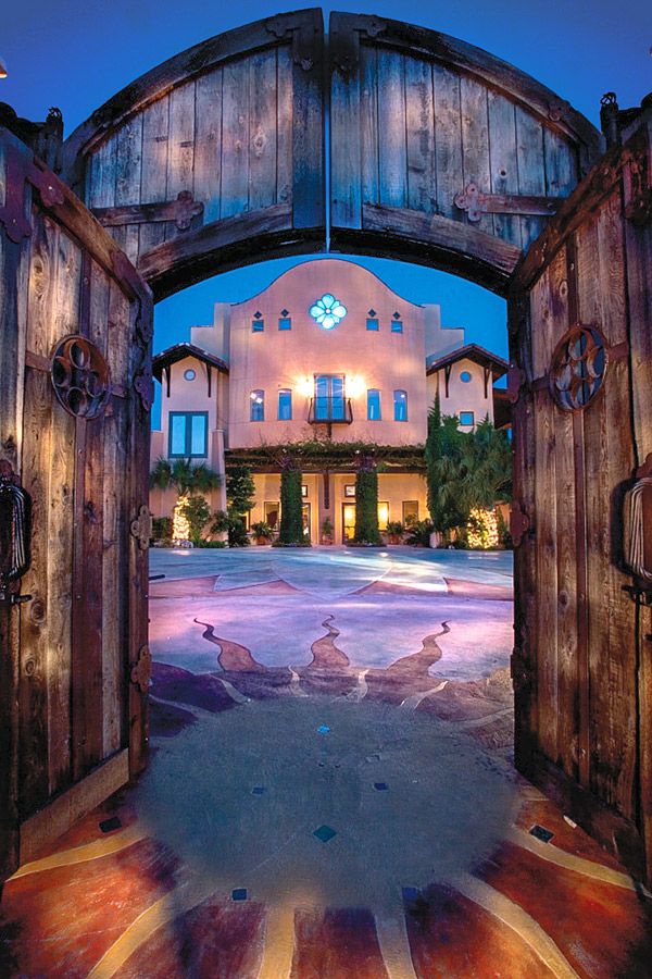 For this courtyard of One World Theatre in Austin, Texas, acid staining, combined with solid-color pigmentation in darker areas, was used on the hand-cut concrete design. The decorative concrete patterns serve as geometric extensions of the building forms, intersecting with the principal focusthe 28-foot lotus flower. Photo courtesy of Marley Porter, Living Architecture and Construction Management