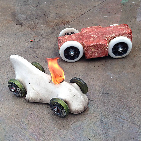 Grand prize winner Peter Cicalos car (left, aflame) was made entirely of concrete. Buddy Rhodes entry (right) won the most heats. Photo by Jeremy French