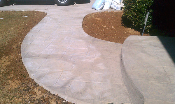 sidewalk with curing blankets and blotchy marks