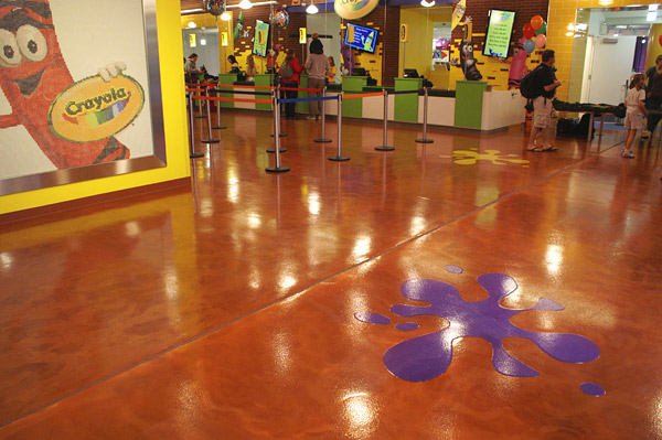 A metallic epoxy coating produced the rich, deep tone of this floor treatment. A polyaspartic with a fine, nonskid additive was used as the floors topcoat. It was also used to create the splashes of color.