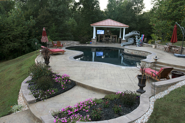 Greystone Masonry masterfully employed layers of hardscape to accommodate this sloping lot.