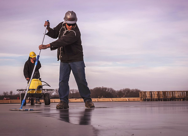 Photos courtesy of Prosoco Workers apply Prosoco's Consolideck surface hardener. Go Green in Decorative Concrete