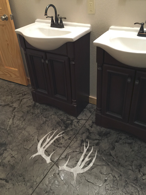 antlers on grey and black stamped concrete floor