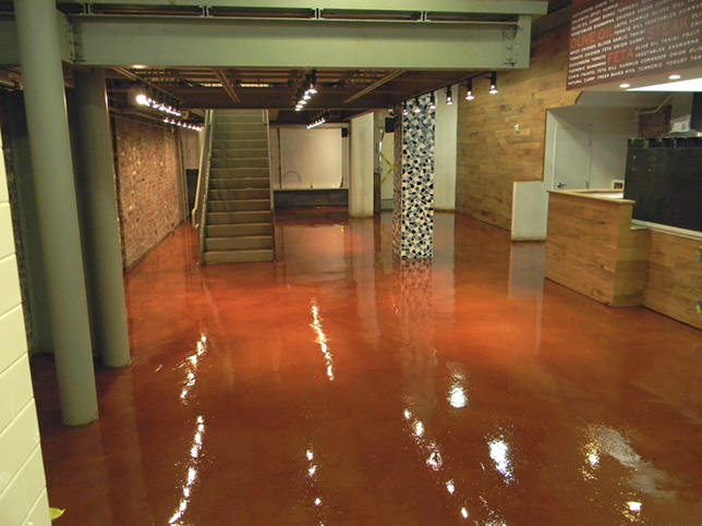 shiny brown floor in lobby area with grey stairs