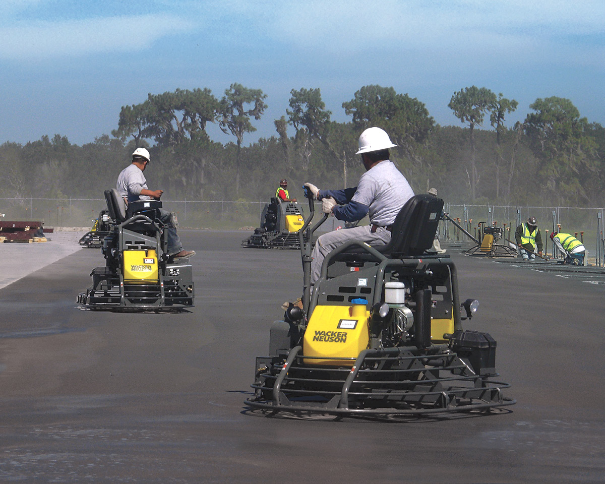 Ride-on power trowels on a large outdoor slab