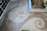 A patio that has been engraved and colored to add life to an otherwise drab space,
