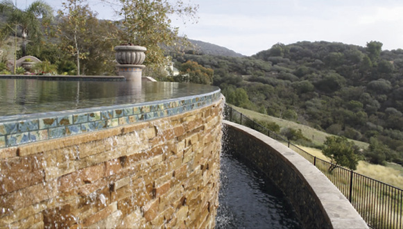 large outdoor pool with beautiful green landscaping
