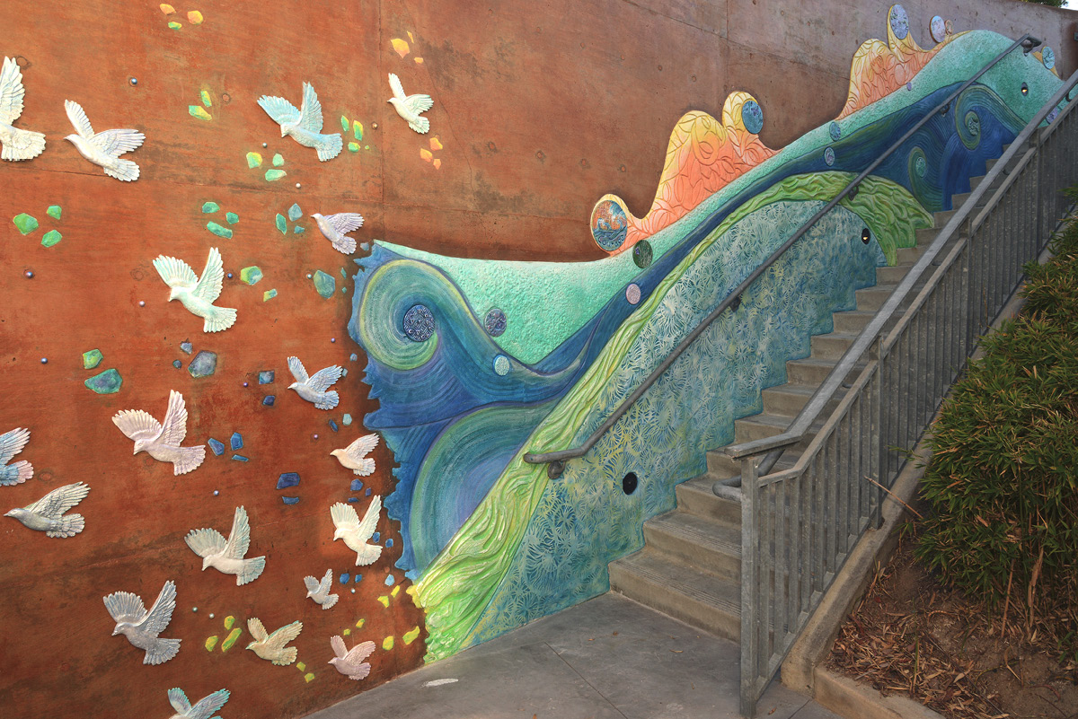 bas relief public mural of doves and waves