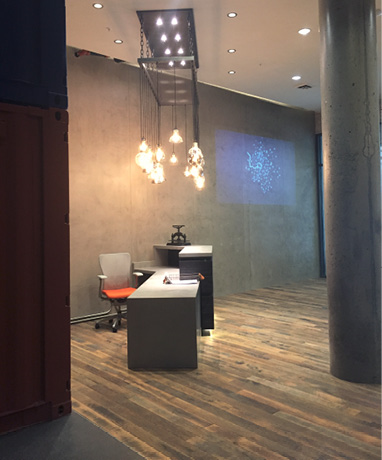 The application included multiple layers of cementitious plaster with integral color and hard troweling.