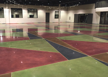 The crisp, detailed line work required more than 2 miles of tape and plastic. The new sections colors and pattern were achieved with a four-dye combination to match the existing floors.
