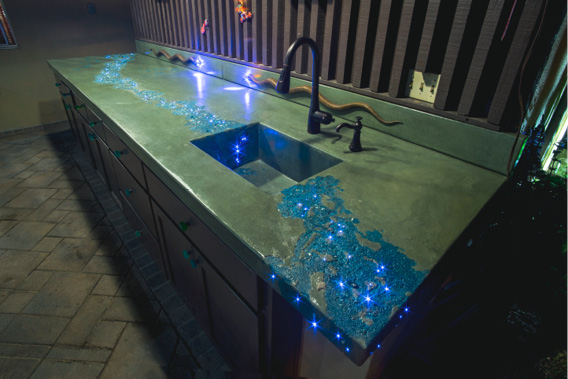 Countertops have blue veins and more than 300 individual fiber optics that twinkle like stars. Large bronze snakes with blue LED eyes slither across green backsplashes.