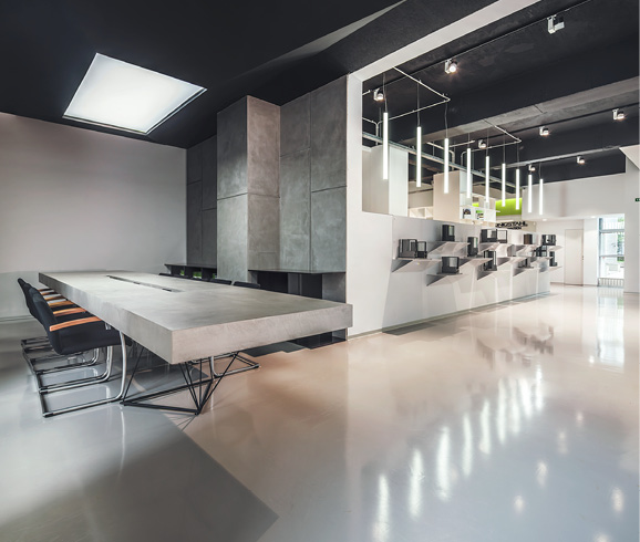 Polished white concrete floors in a meeting space in Italy.