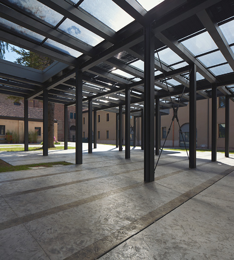 Concrete floor is dignified by the clear roofing with steel support beams.