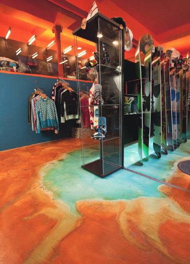 Bright blue and orange stained concrete floor in an Italian boutique.