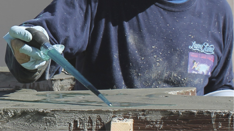 Much like an artist uses a brush for creative effects, Ralston sometimes uses a turkey baster filled with retarder to expose aggregate for stunning results.