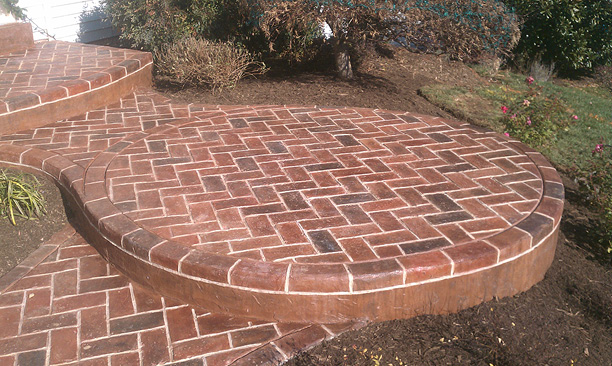 Brick look concrete overlay on a multi step porch entrance.