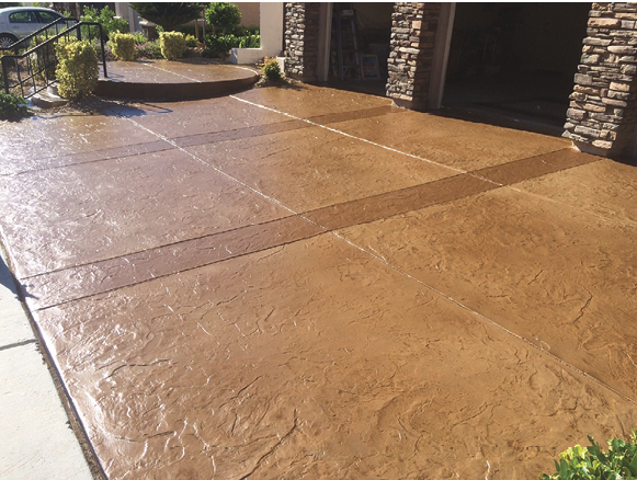 A formerly drab concrete driveway comes alive with an Italian slate pattern using stamped concrete overlays.