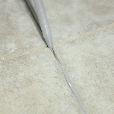 Filling a concrete joint with polyurea joint filler.