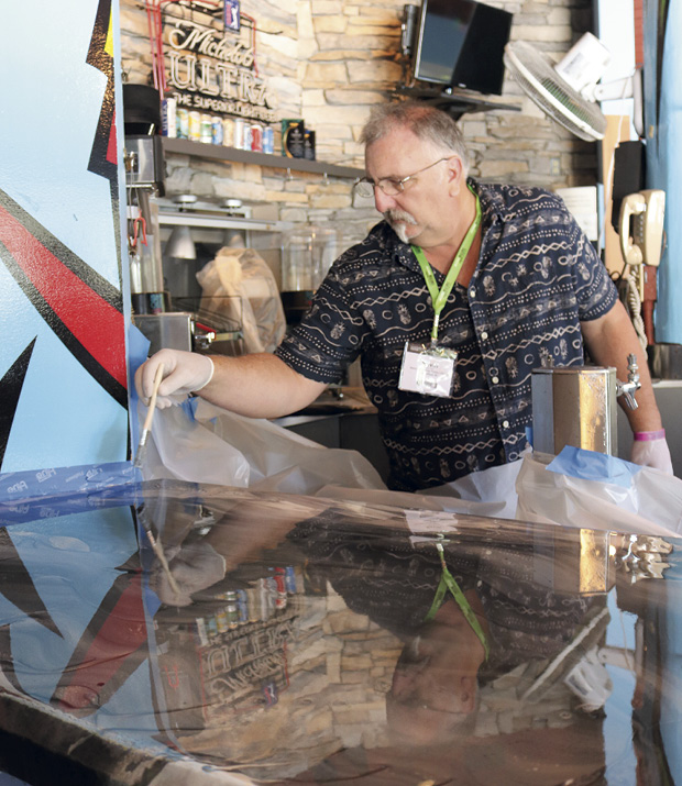 Participants were very hands-on during this workshop as they swirled in the colors with a variety of tools and watched the trainers torch the coating for special effects.