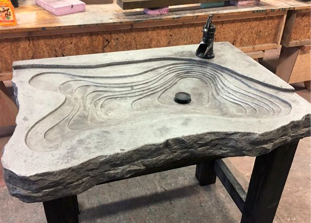 Free standing grey concrete sink. Sediment layered look with a broken rock face edging. Photos courtesy of Concrete In-Counters concrete sink