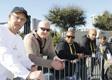 A group of guys holding up the fence at Concrete Decor's Decorative Concrete Live at World of Concrete 2018.