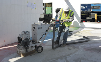 Arcon uses a grinder to smooth a epoxy terrazzo floor at Concrete Decor's Decorative Concrete Live at World of Concrete 2018.
