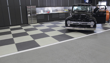 The Sundek crew prepped the surface with a mechanical grind and pressure wash before hand-taping a custom pattern and applying custom colors.