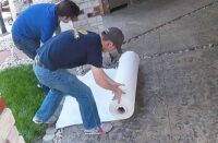Rolling out Deco-Peel fabric to prepare for sealer removal