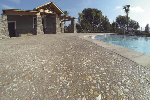 This gray-concrete pool deck was blasted to take the edges off the shell aggregate. Integral coloring was used in the miniature golf project. Photo courtesy of Edwards Bomanite