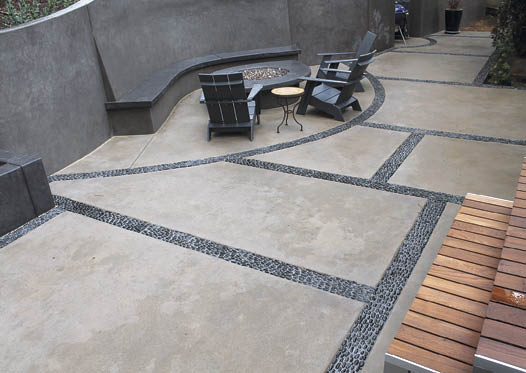Dorsal fin bands are another creative way to use an unorthodox type of aggregate. For these bands, or veins, 2-inch flat Mexican black pebbles are turned on their side to resemble a fin. Installation is painstaking one at a time. The fins create an impression of fish swimming upstream. Photo courtesy of Tom Ralston Concrete