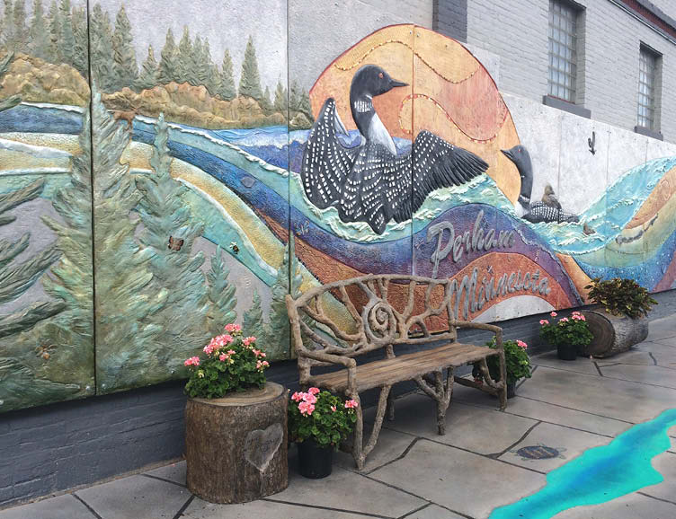 Concrete wall in Perham Minnesota that has been colored and designed with inspired art.