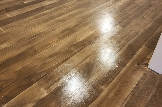 Brian Raub with Brinycrete Decorative Concrete in Lafayette, Indiana, appreciates the versatility of a microtopping, a product he uses to create both wood-look flooring and hand-carved flagstone patterns.